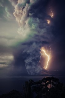 The billows of smoke with lightning is seen from the eruption of the volcan island Taal .The Taal