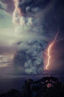 The billows of smoke with lightning is seen from the eruption of the volcan island Taal .The Taal