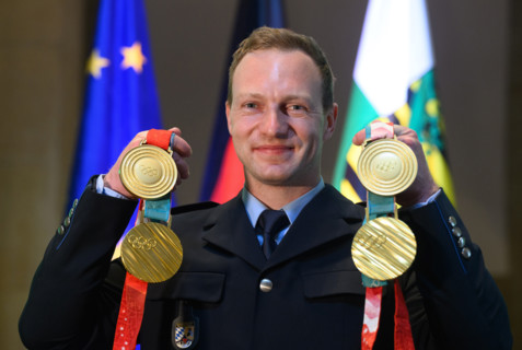 Francesco Friedrich, four-time Olympic bobsleigh champion, presents his gold medals from Beijing