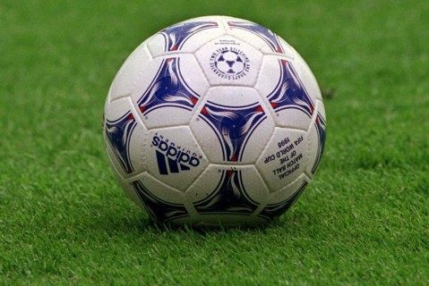 The official ball for the 16th soccer world cup lies on the pitch in the stadium in Lens, France,