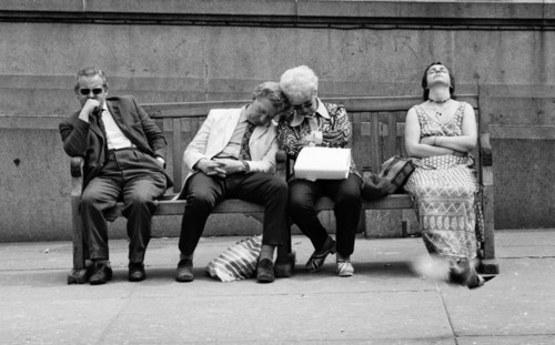 Four People Resting on Street Bench