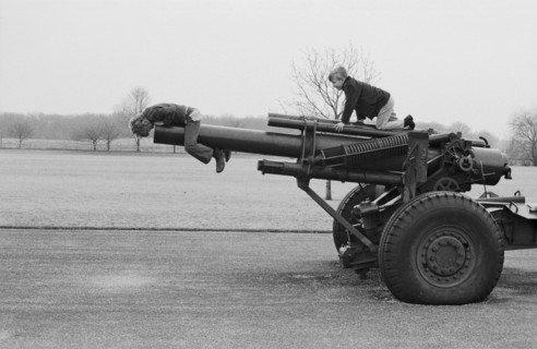 Two Boys Playing on Old Cannon