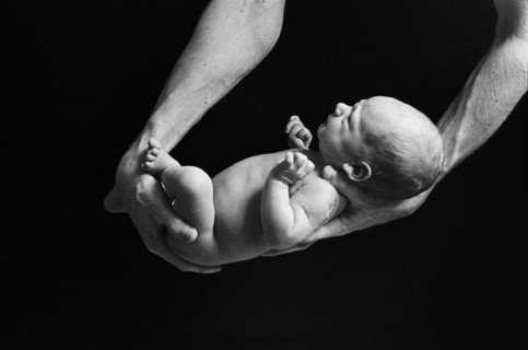 Father Holding Newborn Baby