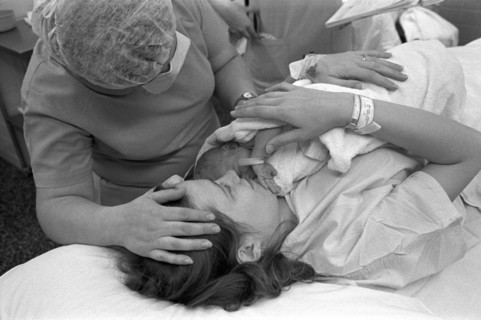 Hospital Nurse Attending Mother With Newborn Baby