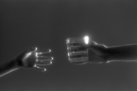 Hands Passing Glass of Water
