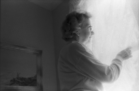 Elderly Woman Looking Out Window