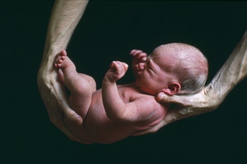 Father Holding Newborn Baby