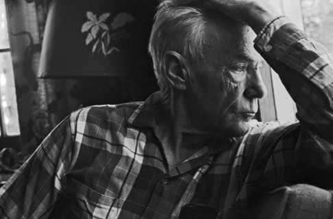 Elderly Man Looking Out Window