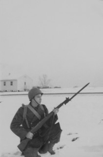 Military Soldier in Uniform Kneeling in Snow with Rifle & Bayonet, Portrait, WWII, HQ 2nd Battalion, 389th Infantry, US Army Military Base, Indiana, USA, 1942
