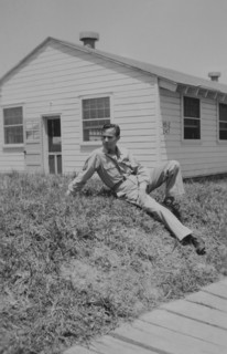 Soldier Relaxing on Ground Near Military Building, WWII, 325th Infantry, US Army Military Base, Camp Claiborne, Louisiana, USA, 1942