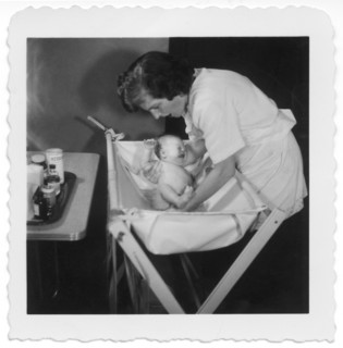 Mother Bathing Newborn Baby, 1952