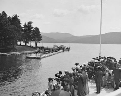 Group of People on Boat Approaching Sagamore Dock, Green Island, Lake George, New York, USA, Detroit Publishing Company, 1904