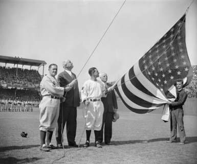 New York Yankee Manager Joe McCarthy, Postmaster General James A. Farley, Washington Senator's Manager Bucky Harris, and Clark Griffith, owner of Senators, Raising Flag before First Baseball Game of S...