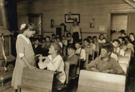 Older Student Conducting Daily Inspection of Teeth and Finger Nails of other Students under the Direction of Teacher, Lawton, Oklahoma, USA, Lewis Hine, 1917