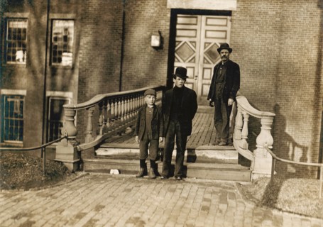Young Boy Going to Work as Sweeper at Textile Mill at 5:30am, Boy is Illiterate and is Brought to and From Work by His Father (right) Every Day, Lewiston, Maine, USA, Lewis Hine, 1909