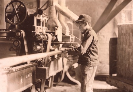 Young Boy Taking Boards away from Double Cut-Off Machine at Lumber Mill, Peru, Indiana, USA, Lewis Hine, 1908