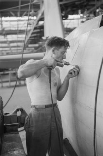 Worker Drilling Holes for Rivets in a Fuselage on a Sub-Assembly Line, Vultee Aircraft Company, Nashville, Tennessee, USA, Jack Delano for Office of War Information, August 1942