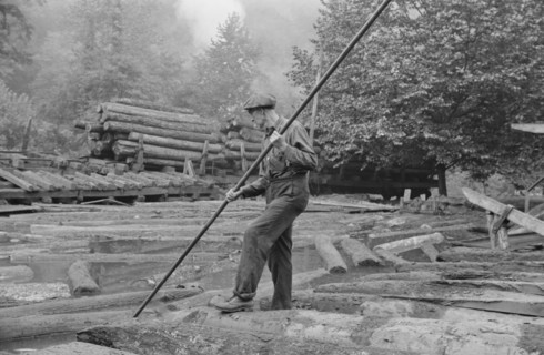 Man Spiking Logs to go up Ramp to Sawmill, Erwin, West Virginia, USA, Marion Post Wolcott for Farm Security Administration, September 1938