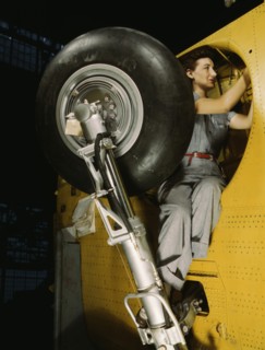 Female Worker Making Final Adjustments in Wheel Well of Inner Wing Before Installation of Landing Gear, Vultee "Vengeance" Dive Bomber, Nashville, Tennessee, USA, Alfred T. Palmer for Office of War In...