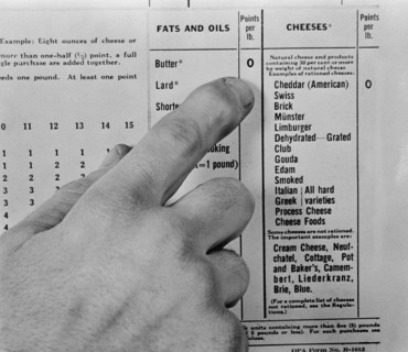 Finger Pointing to Chart of Point Values for Rationed Food Items during WWII, USA, Alfred T. Palmer for Office of War Information, March 1943