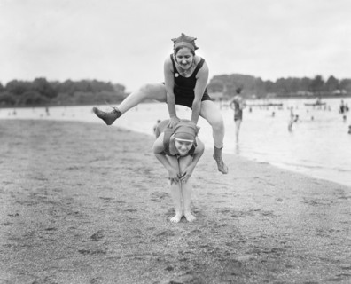 Two Young Women Playing Leap Frog on Beach, USA, National Photo Company, 1921