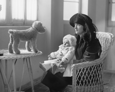 Mrs. P.A. Drury and Infant Child Staring at Stuffed Toy Dog, National Photo Company, 1922