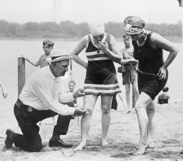 Bill Norton, Bathing Beach "Cop", Using Measuring Distance Between Woman's Knee and Bottom of Bathing Suit at Beach, Washington DC, USA, National Photo Company, 1922