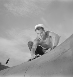 Aviation Machinist's Mate, 2nd Class, Keeping Airplane in Top Condition at Naval Air Base, Corpus Christi, Texas, USA, Howard R. Hollem for Office of War Information, August 1942
