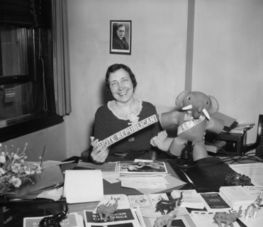 Woman at Office Desk Holding "Vote Republican" Sign and GOP Elephant, Harris and Ewing, 1936