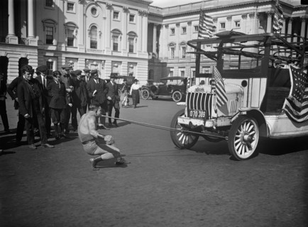 Man Pulling Bus with Teeth outside U.S. Capitol Building, Washington DC, USA, Harris & Ewing, 1921