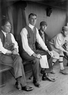Connie Mack, Baseball Manager, Philadelphia Athletics, Portrait Seated in Dugout with Players, Harris & Ewing, 1913