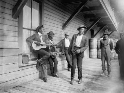 Group of Men Playing Music and Dancing on Porch, "Waiting for the Sunday Boat", William Henry Jackson for Detroit Publishing Company, 1902