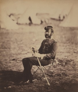 British Major Percy Archer Butler, Seated Portrait in Uniform and Holding Sword with Military Tents in Background, Crimean War, Crimea, Ukraine, by Roger Fenton, 1855
