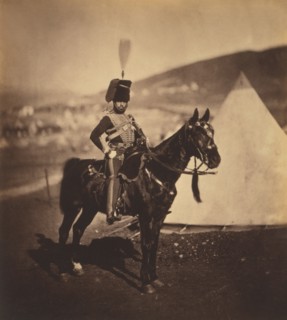 British Cornet Henry John Wilken, 11th Hussars, Seated Portrait in Uniform on Horse, Conical Military Tents in Background, Crimean War, Crimea, Ukraine, by Roger Fenton, 1855