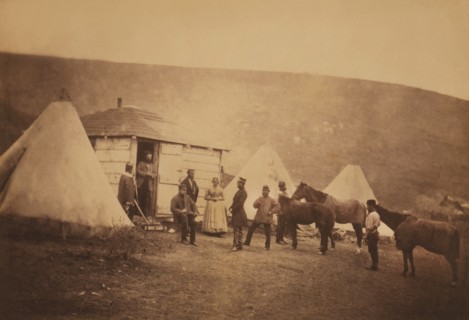 British Captain John MacDonnell Webb, 4th Dragoon Guards, standing in Doorway of Hut looking at Colonel Edward Cooper Hodge (standing in profile), Mrs. Rogers, Webb's servant with a horse, and several...