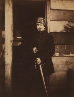 British Captain Francis Baring, Fusilier Guards, Deputy Assistant Quartermaster General, attached to the Light Division, Portrait Standing in Uniform with Hand on Sword at Entrance of Wood Building, C...