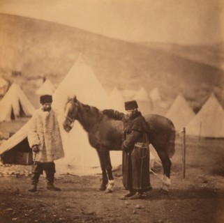 British Colonel Alexander Low, 4th Light Dragoons, Full-Length Standing Portrait in Winter Uniform with Servant and Horse, Military Tents in Background, Crimean War, Crimea, Ukraine, by Roger Fenton, ...
