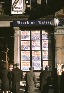 Men and Women Reading Headlines Posted in Street-Corner Window of Brockton Enterprise, Newspaper Office on Christmas Eve, Brockton, Massachusetts, USA, Jack Delano for Farm Security Administration - O...