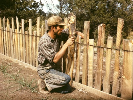 Jack Whinery, Homesteader, Repairing Fence that he built with Slabs, Pie Town, New Mexico, USA, Russell Lee for Farm Security Administration - Office of War Information, September 1940