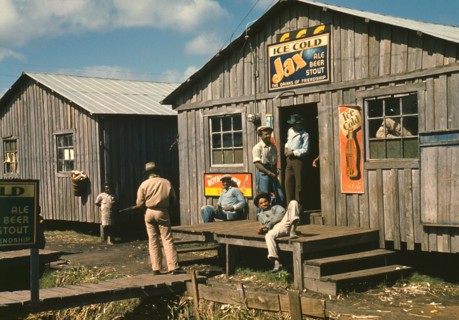 Group of Migratory Workers in front of Living Quarters and Juke Joint, Belle Glade, Florida, USA, Marion Post Wolcott for Farm Security Administration, February 1941