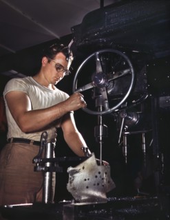 Worker in Drill-Press Section of Machine Shop running Mounting Holes in Large Dural Casting, North American Aviation, Inc., Manufacturer of B-25 Bomber and P-51 Mustang Fighter Planes, Inglewood, Cali...