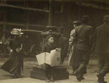 Young Newsboy Selling Newspapers on Sidewalk at Night, St. Louis, Missouri, USA, Lewis Hine for National Child Labor Committee, May 1910