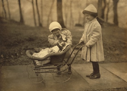 Two Young Girls Playing with Doll in Carriage, New York City, New York, USA, Lewis Hine for National Child Labor Committee, March 1912