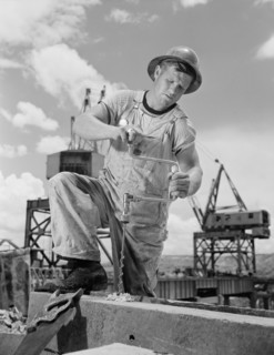 Carpenter Drilling Hole at Tennessee Valley Authority's new Douglas Dam, French Broad River, Sevier County, Tennessee, USA, Alfred T. Palmer for Office of War Information, June 1942