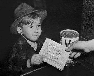 Young Boy with War Ration Book Two at Supermarket, as Children are Being Taught the Facts of Point Rationing during War, Washington DC, USA, Alfred T. Palmer for Office of War Information, February 19...