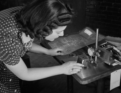 Estelle Wilson, one of a Razor Factory's Many Women Workers, Checking Completed V-blocks with Blueprint Specification, as this factory was Sub-Contracted for Production of War Tools, Boston, Massachus...