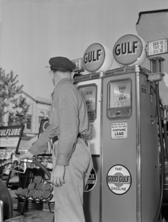 Gas Station Attendant Pumping Gas while Keeping an eye on Gauge during Gasoline Rationing, USA, Office of War Information, 1940's