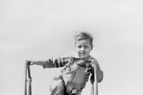 Portrait of Young Boy at Top of Playground Slide, Child of Migratory Worker, Weslaco, Texas, USA, Arthur Rothstein for Farm Security Administration, January 1942