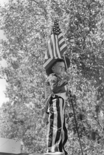 Young Boy in Patriotic Costume Waving American Flag during Fourth of July Parade, Vale, Oregon, USA, Russell Lee, Farm Security Administration, July 1941