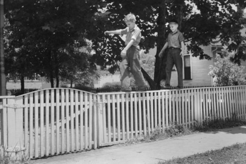 Two Boys Walking on Picket Fence, Washington, Indiana, John Vachon, Farm Security Administration, July 1941